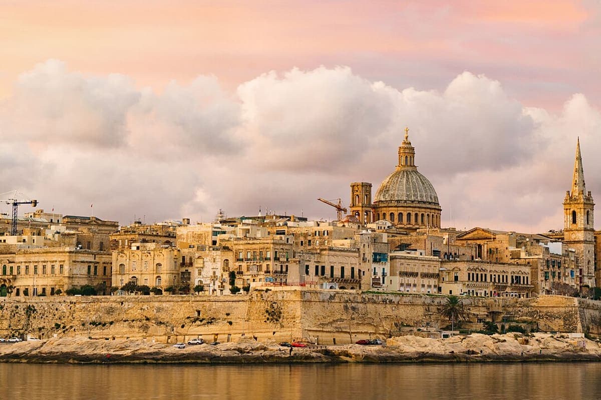 The fortified skyline of Valletta at golden hour, seen across the water