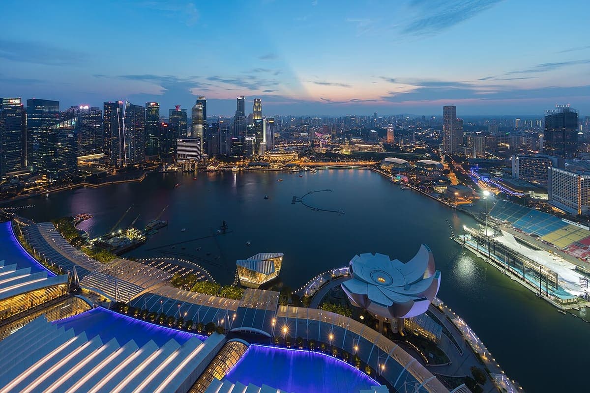 Marina Bay in Singapore at dusk, lit against the city skyline