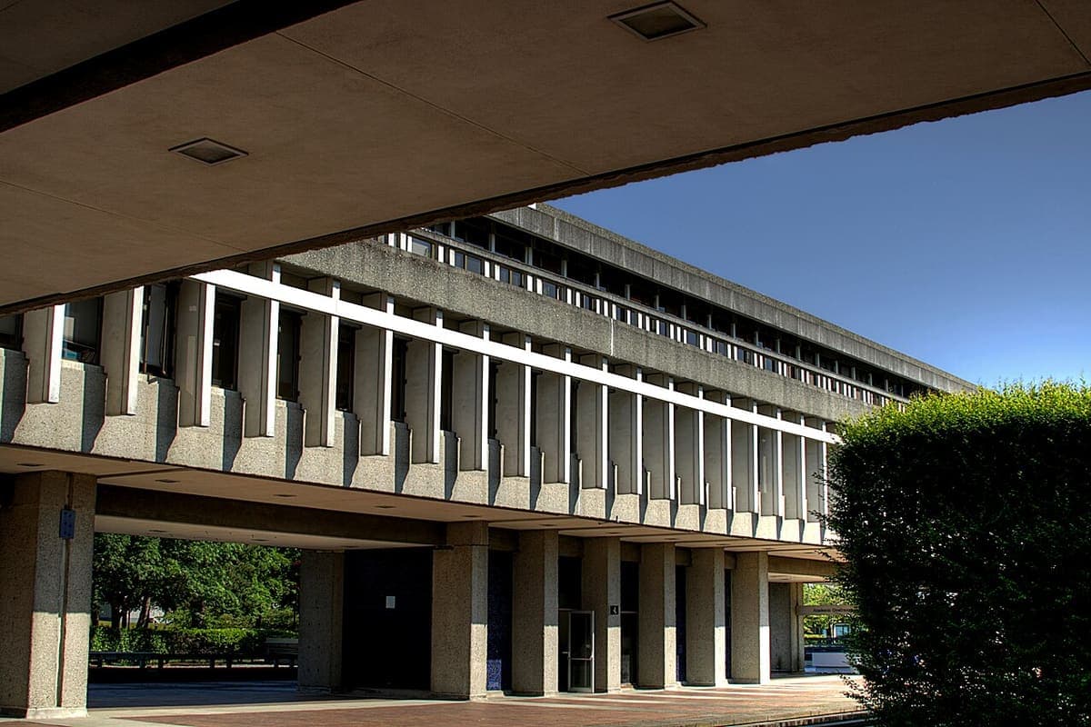 A university building colonnade on a campus walkway